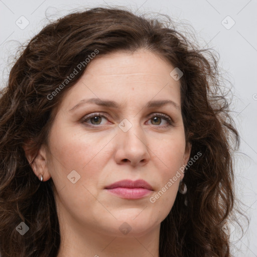 Joyful white adult female with long  brown hair and brown eyes