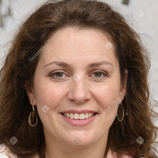 Joyful white adult female with long  brown hair and grey eyes