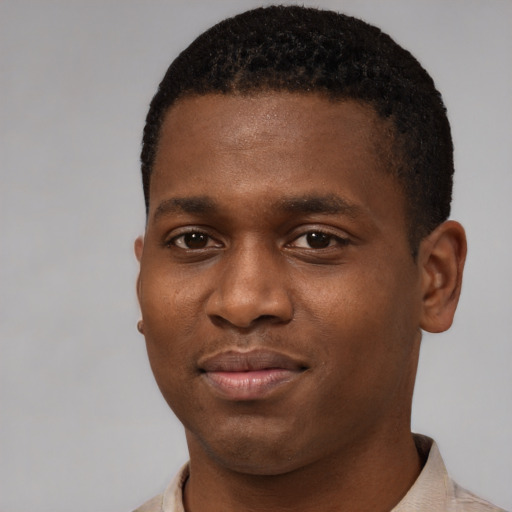 Joyful black young-adult male with short  brown hair and brown eyes