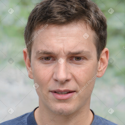 Joyful white adult male with short  brown hair and grey eyes