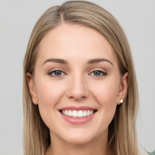 Joyful white young-adult female with long  brown hair and grey eyes