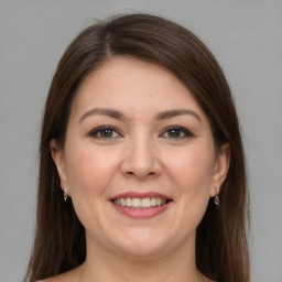 Joyful white young-adult female with long  brown hair and grey eyes