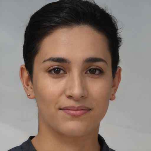 Joyful latino young-adult female with short  brown hair and brown eyes