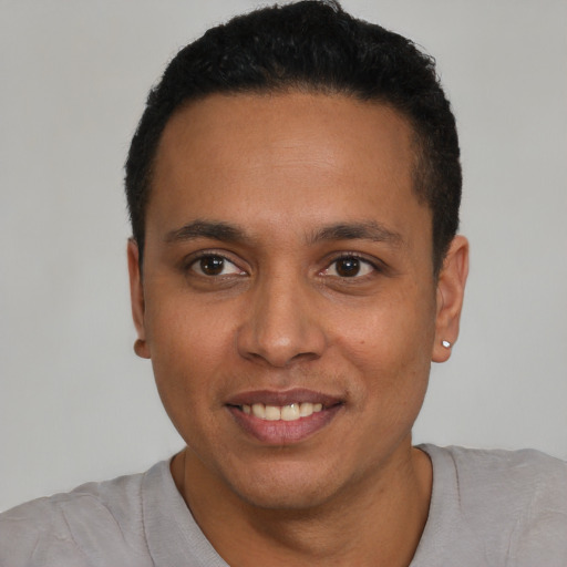Joyful latino young-adult male with short  black hair and brown eyes