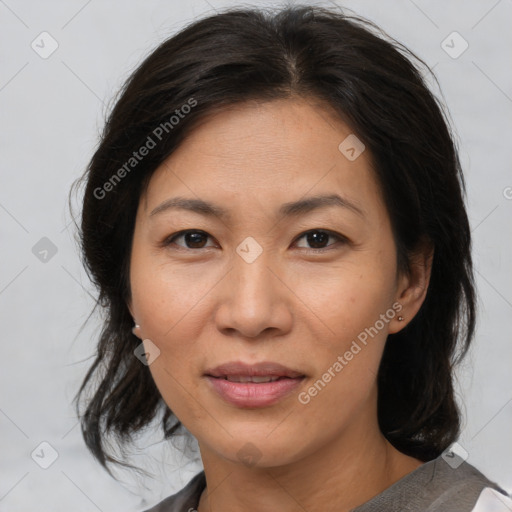 Joyful asian adult female with medium  brown hair and brown eyes