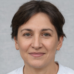 Joyful white adult female with short  brown hair and brown eyes