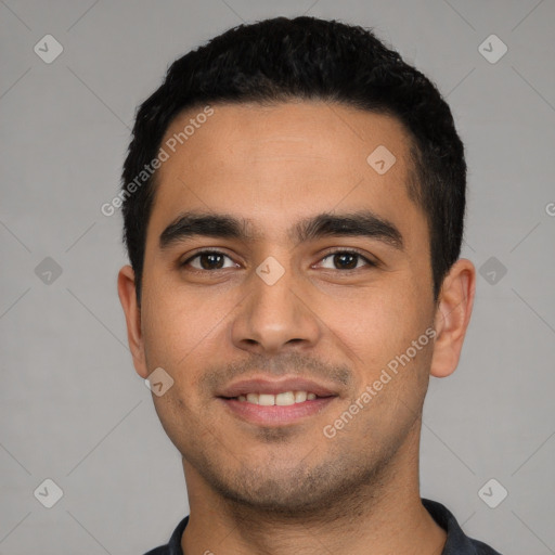 Joyful latino young-adult male with short  black hair and brown eyes