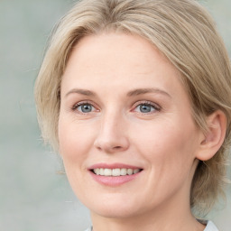 Joyful white young-adult female with medium  brown hair and blue eyes