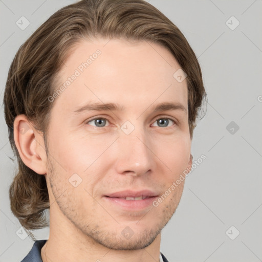 Joyful white young-adult male with medium  brown hair and grey eyes