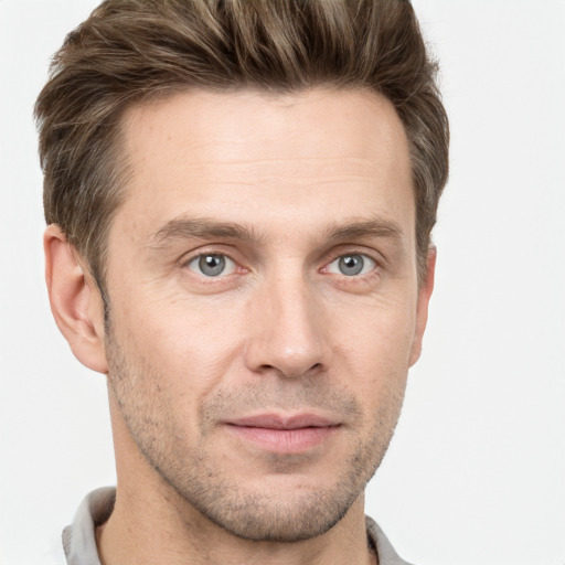 Joyful white adult male with short  brown hair and grey eyes