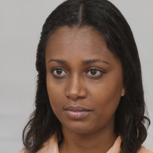 Neutral black young-adult female with long  brown hair and brown eyes