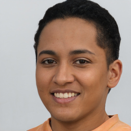 Joyful latino young-adult female with short  black hair and brown eyes