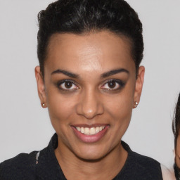 Joyful black young-adult female with short  brown hair and brown eyes