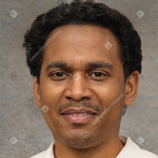 Joyful latino adult male with short  black hair and brown eyes