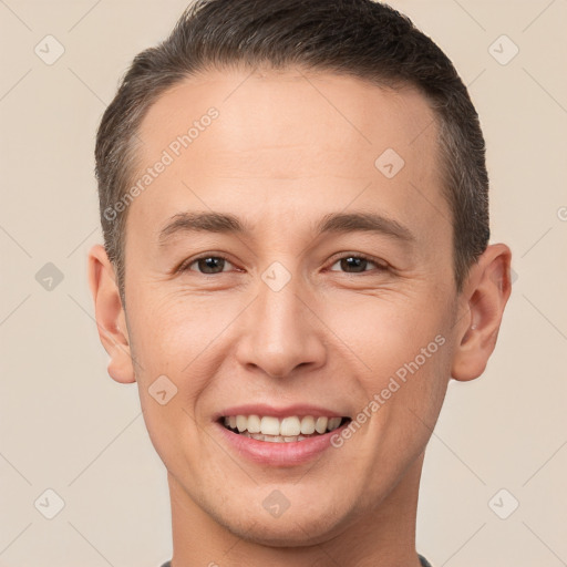 Joyful white young-adult male with short  brown hair and brown eyes