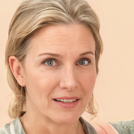 Joyful white adult female with medium  brown hair and blue eyes