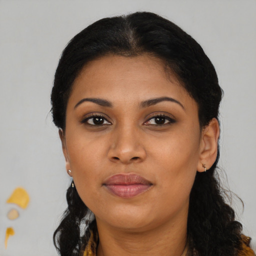 Joyful black young-adult female with long  brown hair and brown eyes