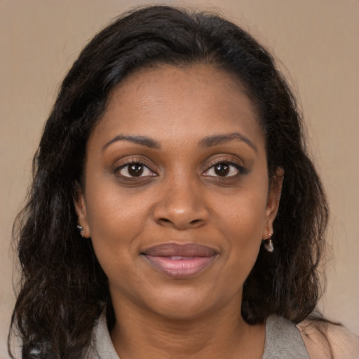 Joyful black young-adult female with medium  brown hair and brown eyes