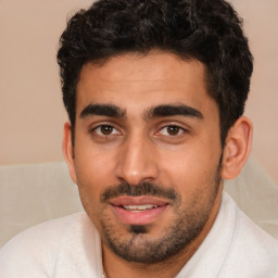 Joyful white young-adult male with short  black hair and brown eyes