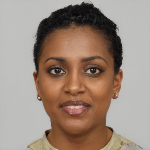 Joyful black young-adult female with short  brown hair and brown eyes