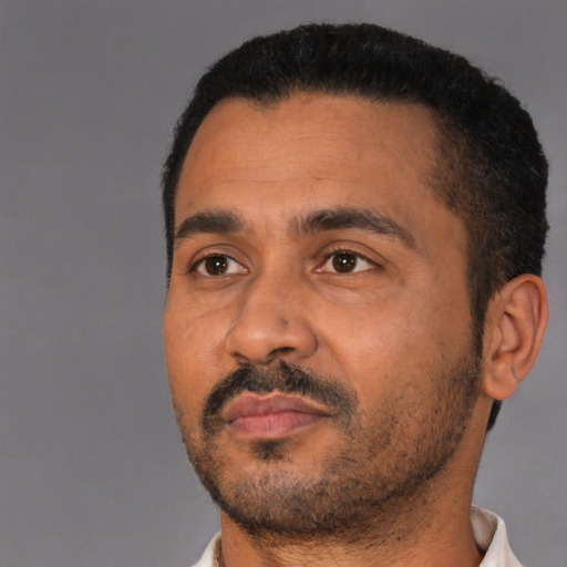 Neutral latino adult male with short  black hair and brown eyes