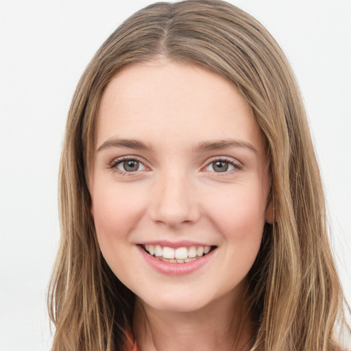 Joyful white young-adult female with long  brown hair and green eyes