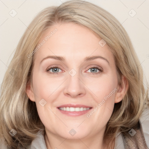 Joyful white adult female with medium  brown hair and blue eyes