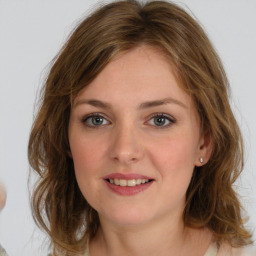 Joyful white young-adult female with medium  brown hair and green eyes