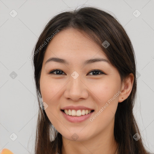 Joyful white young-adult female with long  brown hair and brown eyes