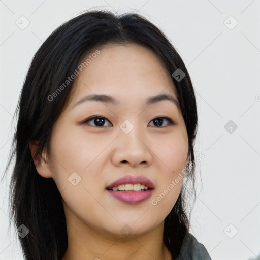 Joyful asian young-adult female with long  black hair and brown eyes