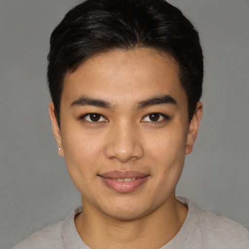 Joyful asian young-adult male with short  brown hair and brown eyes