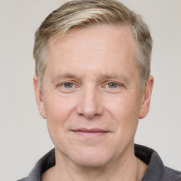 Joyful white adult male with short  brown hair and grey eyes