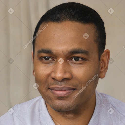 Joyful black young-adult male with short  black hair and brown eyes