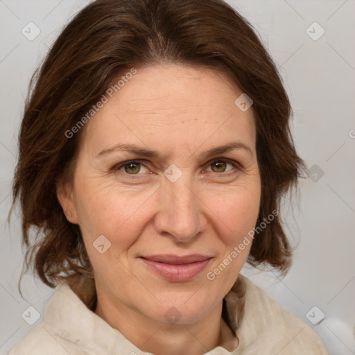 Joyful white adult female with medium  brown hair and green eyes