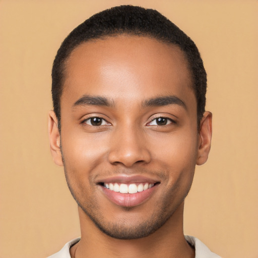 Joyful latino young-adult male with short  brown hair and brown eyes