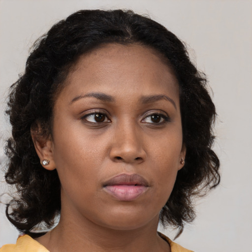Neutral black young-adult female with medium  brown hair and brown eyes