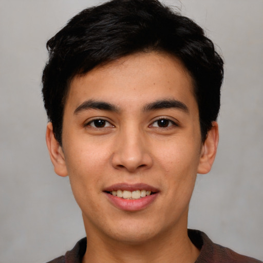 Joyful white young-adult male with short  black hair and brown eyes