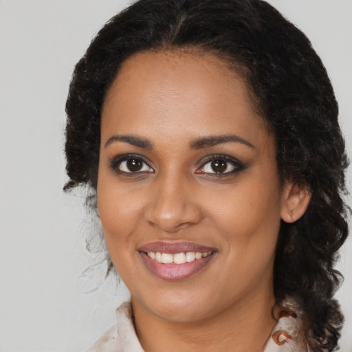 Joyful black young-adult female with medium  brown hair and brown eyes