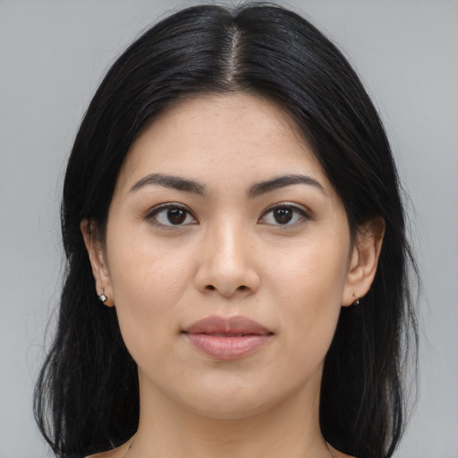 Joyful asian young-adult female with long  black hair and brown eyes