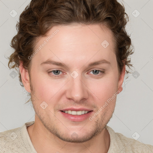 Joyful white young-adult male with short  brown hair and blue eyes