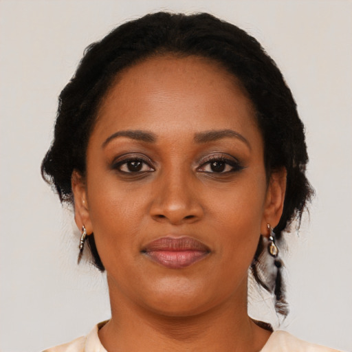 Joyful black young-adult female with medium  brown hair and brown eyes