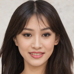 Joyful asian young-adult female with long  brown hair and brown eyes