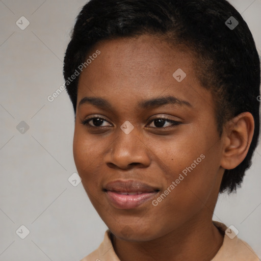 Joyful black young-adult female with short  black hair and brown eyes