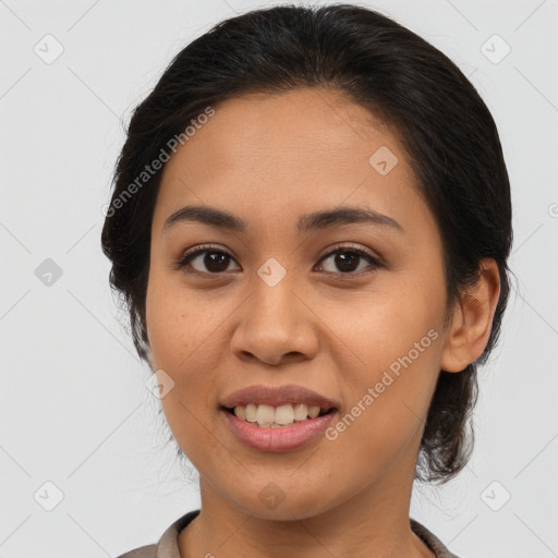 Joyful latino young-adult female with medium  brown hair and brown eyes