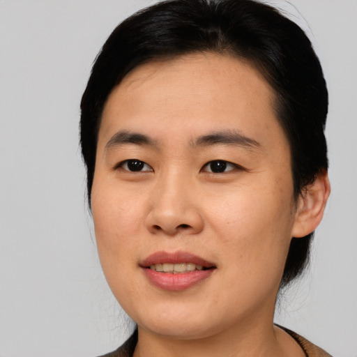 Joyful asian young-adult male with medium  black hair and brown eyes