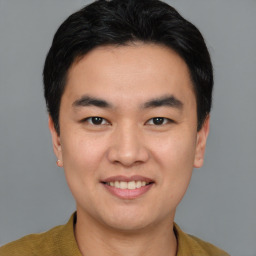 Joyful white young-adult male with short  black hair and brown eyes