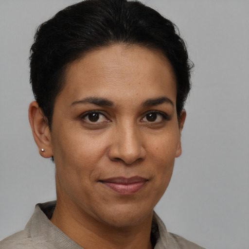 Joyful latino adult female with short  brown hair and brown eyes