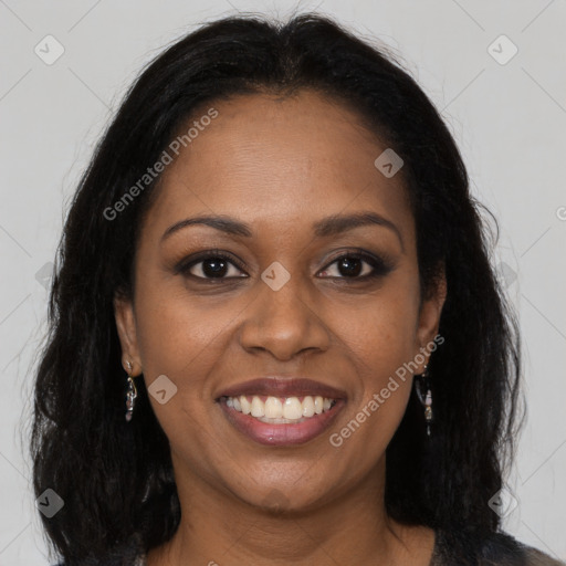 Joyful black young-adult female with long  brown hair and brown eyes