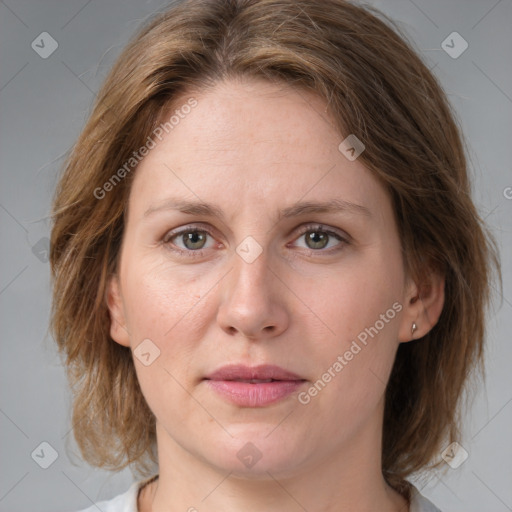 Joyful white adult female with medium  brown hair and grey eyes