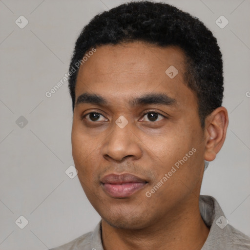 Joyful black young-adult male with short  black hair and brown eyes